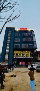 a blue building with people walking in front of it at Hotel 26 in Islamabad