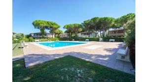 a swimming pool in the backyard of a house at Tivoli in Bibione