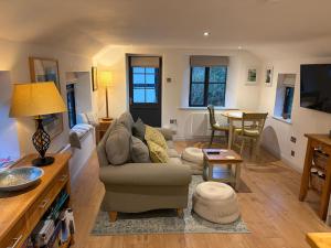 a living room with a couch and a table at The Bakehouse in Castlemorton