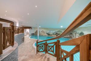 a view of a swimming pool from the stairs of a house at Hotel Mittagskogel Pitztal in Sankt Leonhard im Pitztal