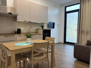 a kitchen and dining room with a wooden table and chairs at SARA - interno 1 - Premium Villas in Giulianova