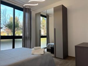 a bedroom with a bed and a large window at SARA - interno 1 - Premium Villas in Giulianova