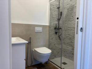 a bathroom with a shower and a toilet and a sink at SARA - interno 1 - Premium Villas in Giulianova +10 photos