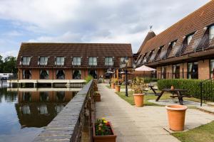 a building next to a canal next to a building at Lakeside International Hotel in Camberley