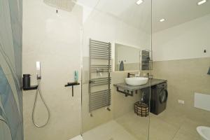 a bathroom with a shower and a sink and a shower at Sunset on Sirmione in Sirmione +22 photos