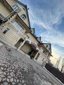 a building with a sign on the side of it at Garnet hotel in Bishkek