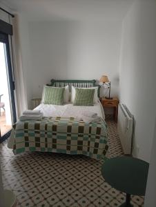 a bedroom with a bed with a checkered floor at Casamanchega13j in Iniesta