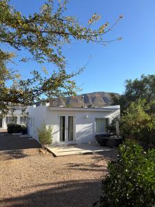 a white house with a driveway at Poplar Karoo Escape in Prince Albert