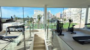 a gym with treadmills and elliptical machines at Casa Rico in Guardamar del Segura