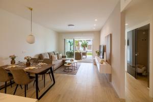 a living room with a table and a couch at Casa Rico in Guardamar del Segura