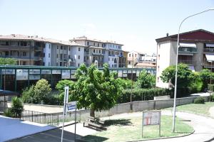a park in a city with buildings in the background at Casa Cate in Poggibonsi
