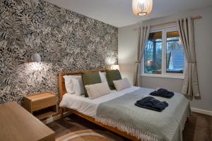 a small bedroom with a bed and a window at Finest Retreats - Toblerone Lodge in Callington +33 photos