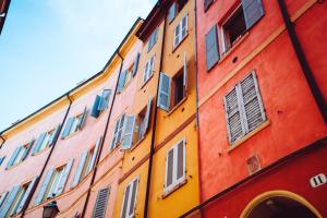 a building with many different colored windows on it at 2D - Home 32 Apartments in Modena