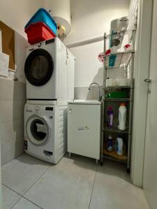 a laundry room with a washing machine and a washer at 2D - Home 32 Apartments in Modena