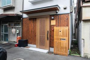 a building with a wooden door in front of it at 三十三Tsuki in Kyoto