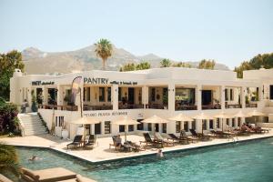 a hotel with a swimming pool and a resort at Naxos Green Village Hotel in Naxos Chora