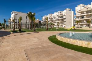 a park with a fountain and some buildings at Casa Rico in Guardamar del Segura