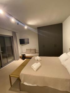 a bedroom with a bed with two towels on it at Aqua villa Studio II in Elafonisos