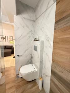 a bathroom with a white toilet in a room at Dvillas one bedroom apartment in Svoronata +6 photos