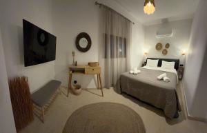 a bedroom with a bed and a bench in it at Dvillas one bedroom apartment in Svoronata