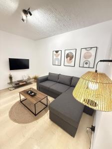 a living room with a couch and a table at Dvillas one bedroom apartment in Svoronata