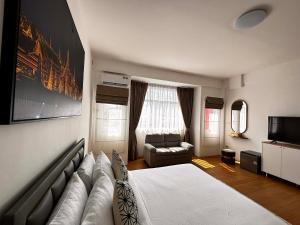 a living room with a large bed and a couch at Phuket gateway inn in Kathu