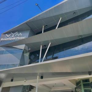 a building with a sign on the side of it at VYM Boutique Hotel in Balulang