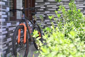 an orange bike parked in front of a house at backpacker's stop in Jagatsukh