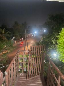 a stairway leading down to a street at night at Ridge Bae Homestay in Varkala