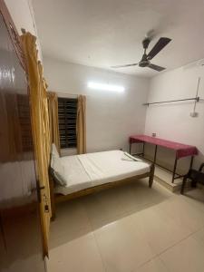 a room with a bed and a table in it at Ridge Bae Homestay in Varkala