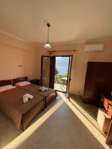 a bedroom with a bed with towels on it at Studios&apartments Thomas in Vasiliki