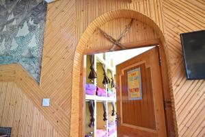 a door to a room with a bunch of shoes at backpacker's stop in Jagatsukh +63 photos