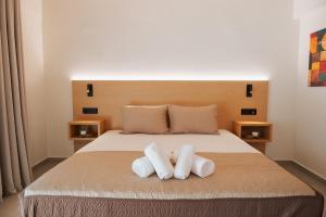 a bedroom with a bed with two towels on it at Olive 203 in Nafplio