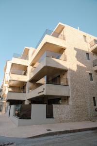 a building with balconies on the side of it at Olive 203 in Nafplio