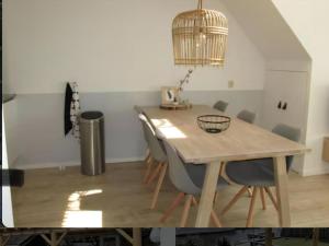 a dining room with a wooden table and chairs at Park De Markol Love Lemmer in Lemmer