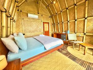 a bed in a room in a yurt at MareCoves Resort & Glamping in Cilangkahan