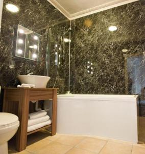 a bathroom with a shower and a sink and a toilet at The Pack Horse in Louth