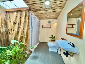a bathroom with a toilet and a sink at MareCoves Resort & Glamping in Cilangkahan