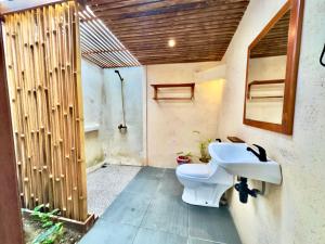 a bathroom with a sink and a toilet at MareCoves Resort & Glamping in Cilangkahan +38 photos