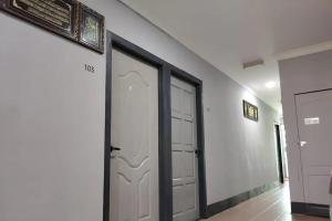 a hallway with two garage doors in a building at Confidence Motel in Kuah