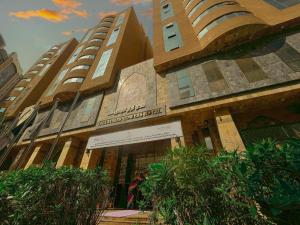 a building with a sign in front of it at Abraj Al Tayseer Tuwa Hotel in Mecca
