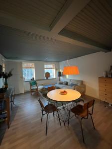 a living room with a table and a couch at Charming townhouse in CityCenter Townhouse - free parking in Odense