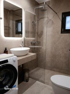 a bathroom with a sink and a toilet and a shower at Lygonis White Houses in Mitika +27 photos