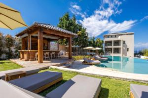 a backyard with a pool and a gazebo at Alissachni SeaSide Hotel in Derveni