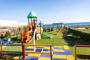 a playground at the beach with a slide at Triscinamare Hotel Residence in Triscina