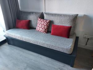 a bench with three pillows on it in a room at Cap ô sud 2 in Cannes +13 photos