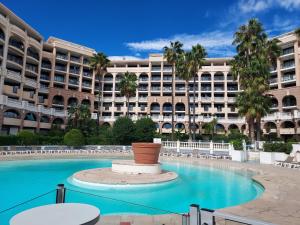 a large building with a large pool in front of it at Cap ô sud 2 in Cannes
