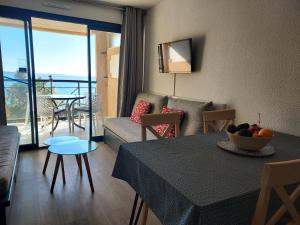 a living room with a table and a couch at Cap ô sud 2 in Cannes