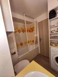 a small bathroom with a sink and a washing machine at Cap ô sud 2 in Cannes