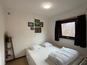 a bedroom with a bed and a window at Coeur de bois - 19 in Petit Mesnil